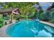Sparkling pool featuring a covered cabana with a seating area, creating a relaxing oasis at 4831 Antioch Church Rd, Matthews, NC 28104