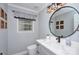 Stylish powder room with modern fixtures, vanity, and window at 4831 Antioch Church Rd, Matthews, NC 28104