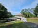 Unique home featuring a carport, surrounding greenery, and a beautiful lakeside view at 500 Steel Bridge Loop, Hickory, NC 28601