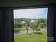 Window view showcasing a picturesque scene with lush trees and a serene lake at 500 Steel Bridge Loop, Hickory, NC 28601