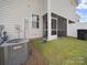View of the home's backyard featuring a screened porch, and healthy grass at 7032 Everly Commons Ln, Tega Cay, SC 29708