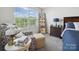 Cozy bedroom with a comfortable chair, decorative ladder and ample natural light at 7032 Everly Commons Ln, Tega Cay, SC 29708