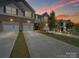 Charming townhome exterior with a two-car garage and well-maintained landscaping at 7032 Everly Commons Ln, Tega Cay, SC 29708