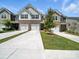 Beautiful townhome exterior showcasing the brick facade, two-car garage and front yard at 7032 Everly Commons Ln, Tega Cay, SC 29708
