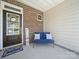 Inviting front porch with a charming bench, a welcoming wreath on the door, and a 'welcome' sign at 7032 Everly Commons Ln, Tega Cay, SC 29708