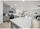 Bright, open-concept kitchen with stainless steel appliances, island seating, and a view to the living area at 7032 Everly Commons Ln, Tega Cay, SC 29708