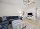 Comfortable living room with a sectional couch, ceiling fan and neutral decor at 7032 Everly Commons Ln, Tega Cay, SC 29708