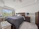 Serene main bedroom with neutral walls, tray ceiling and large windows overlooking trees at 7032 Everly Commons Ln, Tega Cay, SC 29708