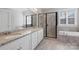 A luxurious bathroom features double sinks, granite counters, soaking tub, and a glass-enclosed shower at 704 Kenway Loop, Mooresville, NC 28117