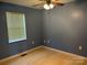 Minimalist bedroom with hardwood floors, blue walls and a single window at 72 Helens Way, Taylorsville, NC 28681