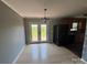 Dining area with French doors to yard, updated lighting fixture, and view into kitchen at 72 Helens Way, Taylorsville, NC 28681