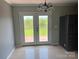 Dining area featuring hardwood floors, a black refrigerator and modern lighting at 72 Helens Way, Taylorsville, NC 28681