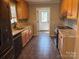 Galley kitchen features granite counters, a tile backsplash and stainless steel appliances at 72 Helens Way, Taylorsville, NC 28681