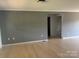 This living room offers light hardwood floors, neutral walls and a minimalist aesthetic at 72 Helens Way, Taylorsville, NC 28681