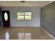 Inviting living room boasts natural light from a large window and features stylish wood-look flooring at 72 Helens Way, Taylorsville, NC 28681