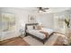 Bright bedroom with modern ceiling fan, hardwood floors, and a cozy decor at 8025 Cliffside Dr, Charlotte, NC 28270