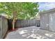 Backyard featuring a concrete patio with a wooden privacy fence and mature shade trees at 8062 Knights Bridge Rd, Charlotte, NC 28210