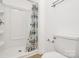 Clean bathroom with a shower and tiled floor, featuring a floral shower curtain at 8062 Knights Bridge Rd, Charlotte, NC 28210