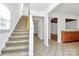 Foyer leading to living spaces with tile flooring, staircase, and partial view of the kitchen at 8062 Knights Bridge Rd, Charlotte, NC 28210