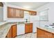 Well-lit kitchen with oak cabinets, granite countertops, tile floors, and modern appliances at 8062 Knights Bridge Rd, Charlotte, NC 28210