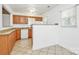 Kitchen featuring oak cabinets, tile floors, granite countertops and a partial divider at 8062 Knights Bridge Rd, Charlotte, NC 28210