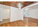 Bright living room with hardwood floors, decorative ceiling and view into the dining room at 8062 Knights Bridge Rd, Charlotte, NC 28210