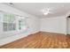 Bright living room with hardwood floors, natural light, and a view of the outdoors at 8062 Knights Bridge Rd, Charlotte, NC 28210