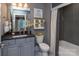 Bathroom featuring gray tiling, dual shower-tub combo, and modern fixtures at 1074 Wylie Falls Ln, York, SC 29745