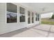 Covered porch features large windows and a door leading to the backyard, perfect for outdoor entertaining at 1074 Wylie Falls Ln, York, SC 29745