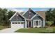 Charming single-Gathering home featuring a two-car garage, covered front porch, and red shutters at 1074 Wylie Falls Ln, York, SC 29745