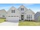 Charming home with white siding, a two-car garage, well-manicured lawn, and stylish curb appeal at 1074 Wylie Falls Ln, York, SC 29745