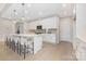 Open-concept kitchen featuring a large island with pendant lighting, white cabinets, and hardwood floors at 1074 Wylie Falls Ln, York, SC 29745