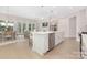 Open-concept kitchen with island, stainless steel appliances, and light wood flooring at 1074 Wylie Falls Ln, York, SC 29745