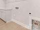 Bright laundry room features modern wood-look floors and convenient countertop space for folding clothes at 1074 Wylie Falls Ln, York, SC 29745