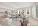 Bright, open-plan living room and kitchen features neutral colors and modern decor at 1074 Wylie Falls Ln, York, SC 29745