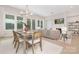 Open-concept living room with large windows, a fireplace, and a dining area at 1074 Wylie Falls Ln, York, SC 29745