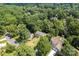 An aerial view of the neighborhood shows the house surrounded by mature trees and greenery at 1109 Sunnyview Cir, Matthews, NC 28105