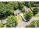 An aerial view shows the house with a long driveway and lush greenery surrounding the property at 1109 Sunnyview Cir, Matthews, NC 28105