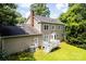 A spacious backyard with a well-maintained lawn and a charming white deck perfect for outdoor relaxation at 1109 Sunnyview Cir, Matthews, NC 28105