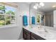 Well-lit bathroom featuring double sinks, dark wood cabinets, large window, and recessed lighting at 1109 Sunnyview Cir, Matthews, NC 28105