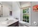 Well-lit half bathroom featuring a modern vanity, toilet, and window with a view at 1109 Sunnyview Cir, Matthews, NC 28105