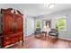 Bedroom featuring hardwood floors, two chairs, two windows, and an antique armoire at 1109 Sunnyview Cir, Matthews, NC 28105