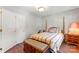 Comfortable bedroom boasts natural light, a bed, hardwood floors, and closet at 1109 Sunnyview Cir, Matthews, NC 28105