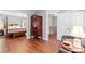 Spacious room with hardwood floors, closet, stairway, and large antique wardrobe at 1109 Sunnyview Cir, Matthews, NC 28105