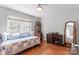 Bedroom featuring a twin bed, large window, hardwood floors, and a dresser at 1109 Sunnyview Cir, Matthews, NC 28105