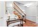 Inviting entryway features hardwood floors, a wooden staircase, and stylish decor at 1109 Sunnyview Cir, Matthews, NC 28105