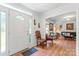 Bright foyer with hardwood floors, decorative door, and a view into the cozy living room at 1109 Sunnyview Cir, Matthews, NC 28105