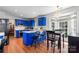 Bright kitchen featuring blue cabinets, white subway tile, breakfast bar, and adjacent dining area with chandelier at 1109 Sunnyview Cir, Matthews, NC 28105