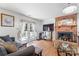 Comfortable living room featuring a brick fireplace, glass coffee table, and doors leading to outdoor space at 1109 Sunnyview Cir, Matthews, NC 28105