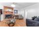 Cozy living room featuring a brick fireplace, hardwood floors, and comfortable seating at 1109 Sunnyview Cir, Matthews, NC 28105